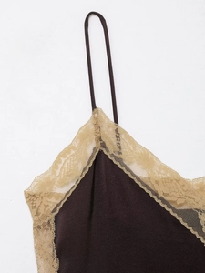 Close-up of chocolate satin fabric and champagne lace trim on a women's top