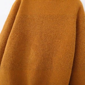 Chic mustard yellow crewneck knit sweater with long sleeves and ribbed texture detailing