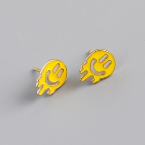 Close-up of S925 sterling silver earrings with yellow melting smiley face enamel