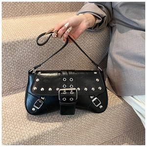 Detail of black Y2K punk shoulder bag with silver rivets and metal buckle hardware