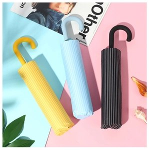 Three striped folding umbrellas in yellow, blue and black with matching portable storage cases