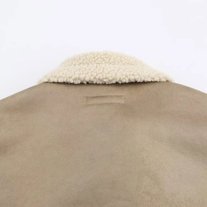Detail of faux suede jacket with warm white faux shearling collar and precision stitching