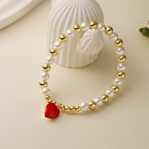 Fashion beaded bracelet with gold copper beads, faux pearls and a red heart pendant