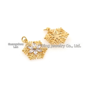 Macro detail of 18k gold plated snowflake pendants with micro-pave cubic zirconia stones