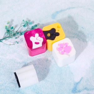Detailed view of DIY cat paw and heart gesture silicone resin molds in pink and yellow