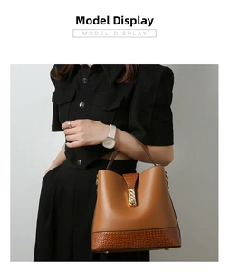 Brown bucket bag detail showing crocodile texture panels and gold metal buckle hardware