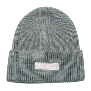 Detail of gray knitted beanie showing vertical rib knit texture and THE FOCUS brand label