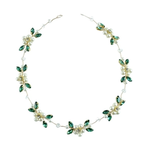 Detail of bridal hair vine with gold wire, green leaves, white pearls and crystals