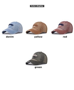 Detail of vintage washed denim baseball caps with distressed holes and 3D embroidery