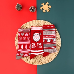 Three-pack festive Christmas crew socks with Santa Claus and snowflake knit patterns