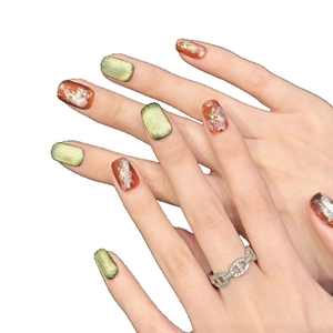 Green cat eye and amber marble press-on nails with gold foil and chain ring detail