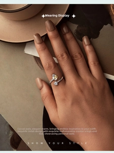 Close-up of 925 sterling silver ring with golden rose and heart zircon on a hand
