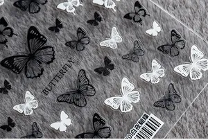 Macro shot of 5D thin adhesive butterfly nail art stickers in white and black tones