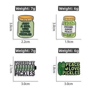 Detail view of four pickle enamel pins with funny slogans on white background