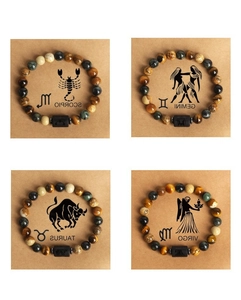 Detail view of zodiac bracelets made of natural tiger eye and lava stones in a grid layout