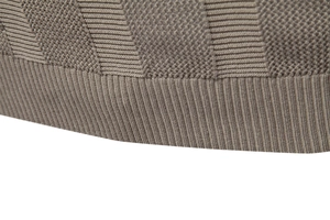 Macro view of brown knit polo shirt showing herringbone texture and ribbed hem detail