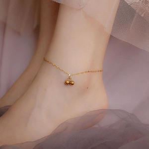 Elegant gold titanium steel anklet with dual sphere pendants worn on the ankle