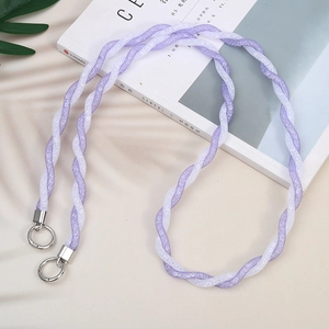 Purple and white braided crossbody phone strap with metallic silver rings on beige background