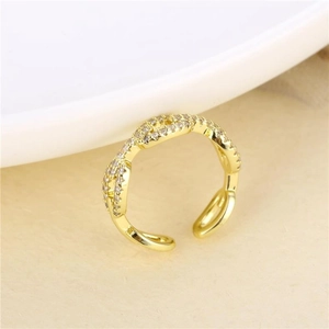 Macro shot of gold-plated twisted rope ring with micro-pave white cubic zirconia