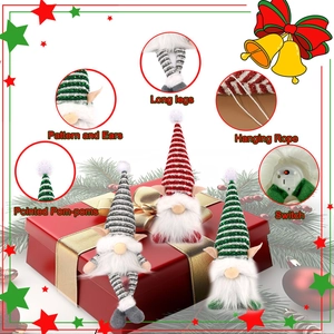 Close-up of lighted Christmas gnomes showing long legs and switch details on gift box