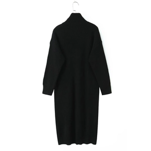 Detail of black long-sleeved cardigan with vertical ribbed knit texture and button closure