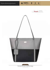 Detail of grey and black patchwork tote bag with long straps and metal logo plate