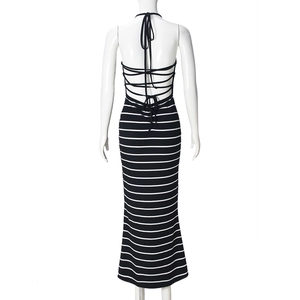 Detail of backless striped halter dress featuring crossed straps and knit texture
