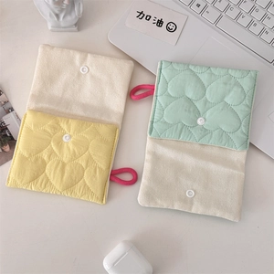 Detailed view of quilted cotton mini pouches with heart stitching in yellow and mint green