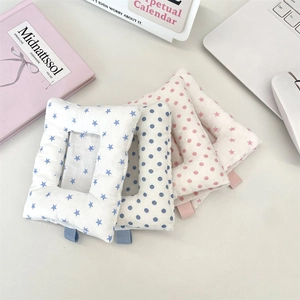 Close-up of cute padded fabric card holders with star and dot patterns and small ribbon loops