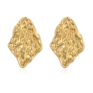 Detail showing irregular geometric gold studs with textured concave and convex metal surfaces