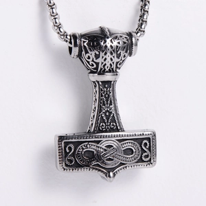 Detail of Viking Thor Hammer Mjölnir pendant in vintage silver with Nordic engravings