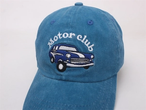 Detail of blue motor club embroidery and vintage car pattern on cotton baseball cap