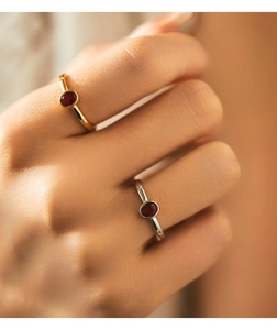 Detailed view of s925 silver rings with oval red gems and side stones on model hands