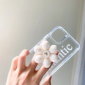 Detail of white 3D flower phone stand with gold heart center on transparent case