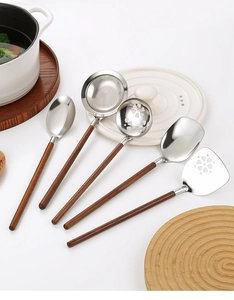 Detail view of 304 stainless steel kitchen utensils set with walnut wood handles