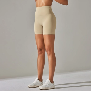 Detailed side view of high-waisted seamless beige yoga shorts with butt-lifting stitching