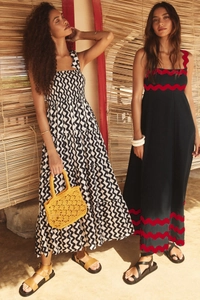 Detail of bohemian tiered floral sundress and dark blue maxi dress with wavy red trim