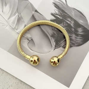 Minimalist twisted cable open cuff bracelet in 18k gold plated stainless steel
