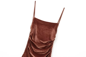 Close-up of brown velvet midi dress showing side ruching detail and thin straps
