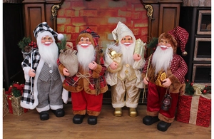 Detailed view of four varied Santa Claus figures in a warm indoor Christmas setting