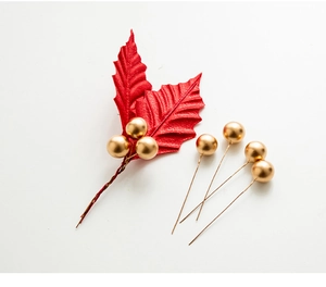 Detail of red holly leaves and gold metallic berries for DIY Christmas wreath crafts