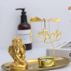 Golden Nordic rotating candle holder with angel sculpture and carousel horse tray
