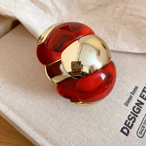 Detailed close-up of marble-textured resin and golden metal geometric elastic bracelet