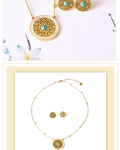 Detail of vintage gold necklace and tree of life earrings with turquoise and diamonds
