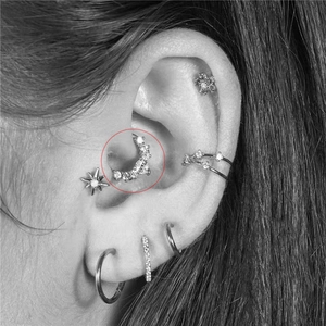 Seamless copper nose ring with zircon bee and angel charms worn on a model's ear