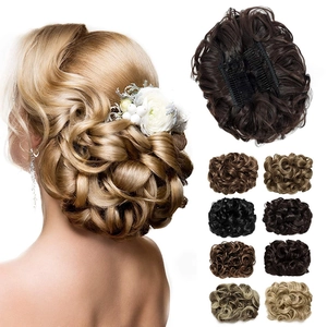 Detail showing various colors of synthetic curly hair bun extensions with clip-in attachment