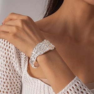 Macro detail of wide silver cuff bracelet with unique heavy metal wrinkled texture
