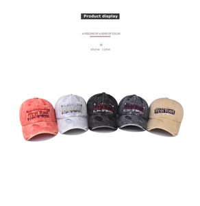 Close-up of washed cotton baseball caps with New York embroidery and distressed vintage details