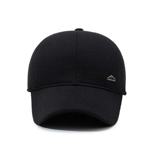 Winter black wool baseball cap with ear protection and silver metal mountain badge