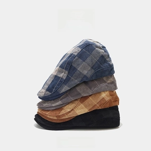 Vintage corduroy plaid beret hats in four colors stacked on a clean white background